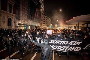 38423612-9181987-Demonstrators_march_with_a_banner_reading_black_clad_resistance_-a-201_1611523433620.jpg