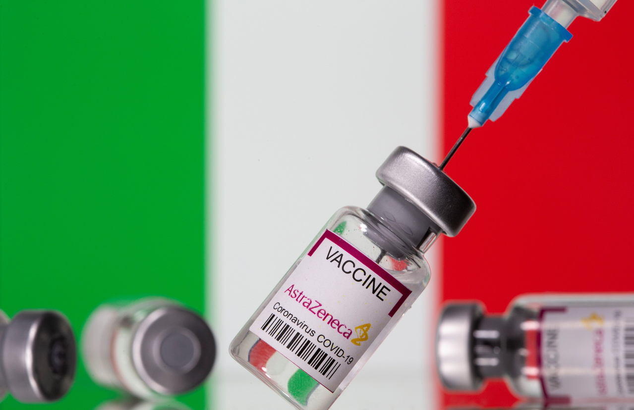 Vials labelled "Astra Zeneca COVID-19 Coronavirus Vaccine" and a syringe are seen in front of a displayed Italy flag, in this illustration photo taken March 14, 2021. REUTERS/Dado Ruvic/Illustration
