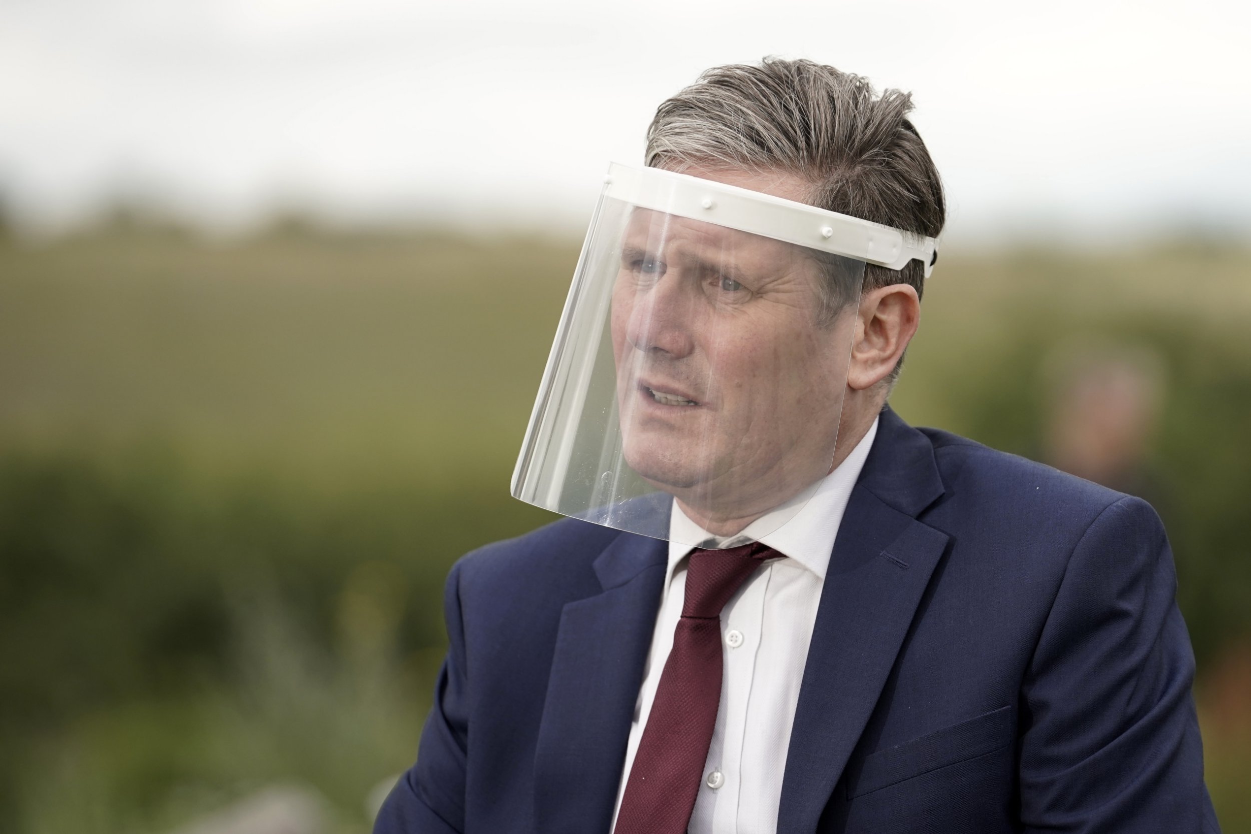 NOTTINGHAM, ENGLAND - JULY 16: Labour Party leader, Sir Keir Starmer, wears a face visor during talks with care home workers and family members of residents during a visit to Cafe 1899 in Gedling Country Park on July 16, 2020 in Nottingham, England. The opposition leader discussed the impact of coronavirus on care homes and the improvements needed ahead of a possible second wave this winter. Care homes for senior citizens in  the UK has seen thousands of deaths due to the Covid-19 pandemic.  (Photo by Christopher Furlong/Getty Images)