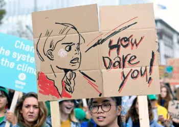 A participant holds a drawing depicting Swedish environmental activist Greta Thunberg during a protest march to call for action against climate change, in The Hague, Netherlands September 27, 2019. REUTERS/Piroschka van de Wouw