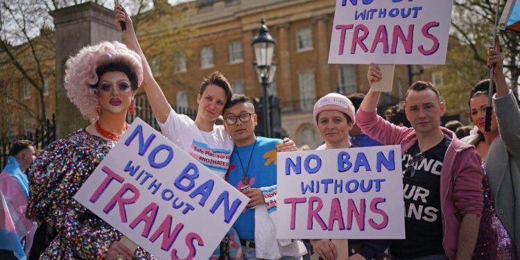 2J3WB4C People take part in a protest outside Downing Street in London, over transgender people not being included in plans to ban conversion therapy. Picture date: Sunday April 10, 2022.