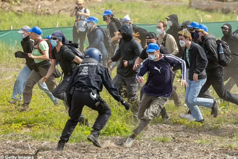 Tesla Gigafactory Shut Down as Hundreds of Anti-Capitalism Protesters Violently Clash With Police and Storm Gates of Facility